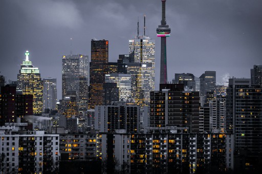 Downtown city skyline at dusk with lit office and residential towers